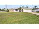 House with a large green lawn and palm trees at 546 Highland Nw Ave, Port Charlotte, FL 33952