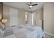 Bedroom with white dresser, ceiling fan, and en-suite bathroom at 5824 Semolino St, Nokomis, FL 34275