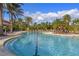 Community pool with lounge chairs and patio umbrellas at 5824 Semolino St, Nokomis, FL 34275