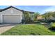 Charming one-story home with a well-manicured lawn, lovely landscaping, and a paver driveway leading to the garage at 5846 Cavano Dr, Sarasota, FL 34231