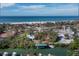 An aerial view of a house in a waterfront neighborhood with a beach at 6161 Gulf Of Mexico Dr, Longboat Key, FL 34228