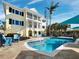 Stunning backyard featuring a large pool, beautiful landscaping, and a spacious outdoor seating area at 6161 Gulf Of Mexico Dr, Longboat Key, FL 34228