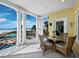 Covered balcony features white columns and beach views with a table and chairs at 6161 Gulf Of Mexico Dr, Longboat Key, FL 34228