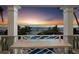 Sunset view from the balcony, showcasing coastal relaxation, dining seating, and the beauty of the ocean at 6161 Gulf Of Mexico Dr, Longboat Key, FL 34228