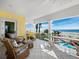 The relaxing balcony offers seating, ocean views, and palm trees for an idyllic outdoor experience perfect for relaxation at 6161 Gulf Of Mexico Dr, Longboat Key, FL 34228