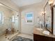 Elegant bathroom featuring glass walk-in shower, marble countertop, vanity, and sophisticated fixtures at 6161 Gulf Of Mexico Dr, Longboat Key, FL 34228