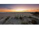 A sunset view of a beach with natural dunes and sparse vegetation, perfect for evening strolls and relaxation at 6161 Gulf Of Mexico Dr, Longboat Key, FL 34228