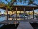 Pontoon boat on a boat lift in a covered dock at 6161 Gulf Of Mexico Dr, Longboat Key, FL 34228