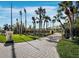 Paver driveway lined with lush landscaping and palm trees leading to the property at 6161 Gulf Of Mexico Dr, Longboat Key, FL 34228