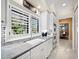 Kitchen with white cabinets, marble countertops, and stainless steel appliances at 6161 Gulf Of Mexico Dr, Longboat Key, FL 34228