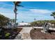 Well-maintained landscaped backyard featuring a paver pathway leading to beach with views at 6161 Gulf Of Mexico Dr, Longboat Key, FL 34228