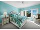 Light-filled main bedroom with blue walls, ocean views, and a ceiling fan at 6161 Gulf Of Mexico Dr, Longboat Key, FL 34228