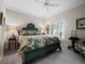Main bedroom with detailed headboard, accent furniture, and a ceiling fan at 6161 Gulf Of Mexico Dr, Longboat Key, FL 34228
