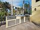 Outdoor kitchen features stainless steel grill, bar area, sink, and ample storage for all your entertaining needs at 6161 Gulf Of Mexico Dr, Longboat Key, FL 34228