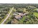 Aerial view of home, pool, and surrounding landscape at 6200 Saddle Oak Trl, Sarasota, FL 34241