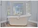 Relaxing bathroom featuring a freestanding soaking tub and large windows at 6200 Saddle Oak Trl, Sarasota, FL 34241