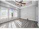 Spacious bedroom with hardwood floors and a ceiling fan at 6200 Saddle Oak Trl, Sarasota, FL 34241
