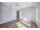 Well-lit bedroom with wood flooring and access to hallway at 6200 Saddle Oak Trl, Sarasota, FL 34241