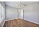 Well-lit bedroom with wood-look floors and ceiling fan at 6200 Saddle Oak Trl, Sarasota, FL 34241