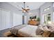 Spacious bedroom with wood flooring, large closet, and tranquil view at 6200 Saddle Oak Trl, Sarasota, FL 34241