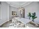 Modern dining room with large windows and stylish light fixture at 6200 Saddle Oak Trl, Sarasota, FL 34241