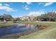 Luxury home showcasing a tranquil pond and lush landscaping at 6200 Saddle Oak Trl, Sarasota, FL 34241
