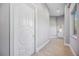 Light-filled hallway with wood-look floors and neutral walls at 6200 Saddle Oak Trl, Sarasota, FL 34241