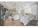 Modern kitchen featuring white cabinets, a large island, and stainless steel appliances at 6200 Saddle Oak Trl, Sarasota, FL 34241