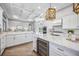 Gourmet kitchen with white cabinets, coffered ceiling, and built-in wine cooler at 6200 Saddle Oak Trl, Sarasota, FL 34241
