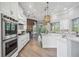 Modern kitchen with white cabinets, stainless steel appliances, and stone accents at 6200 Saddle Oak Trl, Sarasota, FL 34241