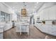 Open concept kitchen with island, white cabinets, and marble countertops at 6200 Saddle Oak Trl, Sarasota, FL 34241