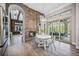 Kitchen nook with white table and chairs near fireplace and access to outdoor space at 6200 Saddle Oak Trl, Sarasota, FL 34241