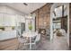 Kitchen nook with white table and chairs, located near a stone fireplace at 6200 Saddle Oak Trl, Sarasota, FL 34241