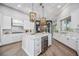 Large kitchen island with wine cooler, white cabinets, and marble countertops at 6200 Saddle Oak Trl, Sarasota, FL 34241