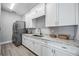 Well-appointed laundry room with granite countertops and ample cabinetry at 6200 Saddle Oak Trl, Sarasota, FL 34241