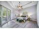 Main bedroom with wood floors,sliding doors to pool area, ceiling fan at 6200 Saddle Oak Trl, Sarasota, FL 34241