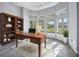 Home office with built-in shelving and large windows at 6200 Saddle Oak Trl, Sarasota, FL 34241