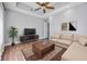 Relaxing sitting room with comfortable sectional sofa and wood floors at 6200 Saddle Oak Trl, Sarasota, FL 34241
