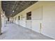 Image shows a row of horse stables with doors and a concrete floor at 6200 Saddle Oak Trl, Sarasota, FL 34241