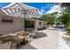 An umbrella shades a back patio with table and chairs, with a view of the backyard and RV parking at 671 47Th St, Sarasota, FL 34234