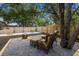 A backyard oasis features a fire pit, comfortable seating, and cornhole for relaxing at 671 47Th St, Sarasota, FL 34234