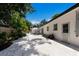 Private backyard featuring a white patio and white gravel border, surrounded by lush landscaping and fencing at 671 47Th St, Sarasota, FL 34234