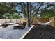 A backyard boasts a fire pit, two chairs, and a hammock; all surrounded by landscaping at 671 47Th St, Sarasota, FL 34234