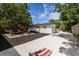 A backyard features a fire pit, seating area, gravel ground cover, and a cornhole game at 671 47Th St, Sarasota, FL 34234