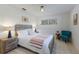 Bright bedroom with a wooden bed frame, modern decor, neutral rug, and large windows offering natural light at 671 47Th St, Sarasota, FL 34234