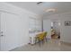 Bright dining area featuring a modern table, terrazzo floors, and easy access to other rooms at 671 47Th St, Sarasota, FL 34234