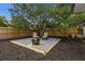 A backyard fire pit is surrounded by two wicker chairs and white gravel at 671 47Th St, Sarasota, FL 34234