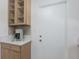 Bright kitchen area with light wood cabinets, neutral countertops, and glass fronted display cabinetry at 671 47Th St, Sarasota, FL 34234