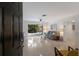 Bright living room with terrazzo flooring, a modern sofa, and sliding glass doors leading to the outdoor patio at 671 47Th St, Sarasota, FL 34234