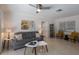 Spacious living room boasts terrazzo floors, comfortable seating, and lots of natural light from the windows at 671 47Th St, Sarasota, FL 34234